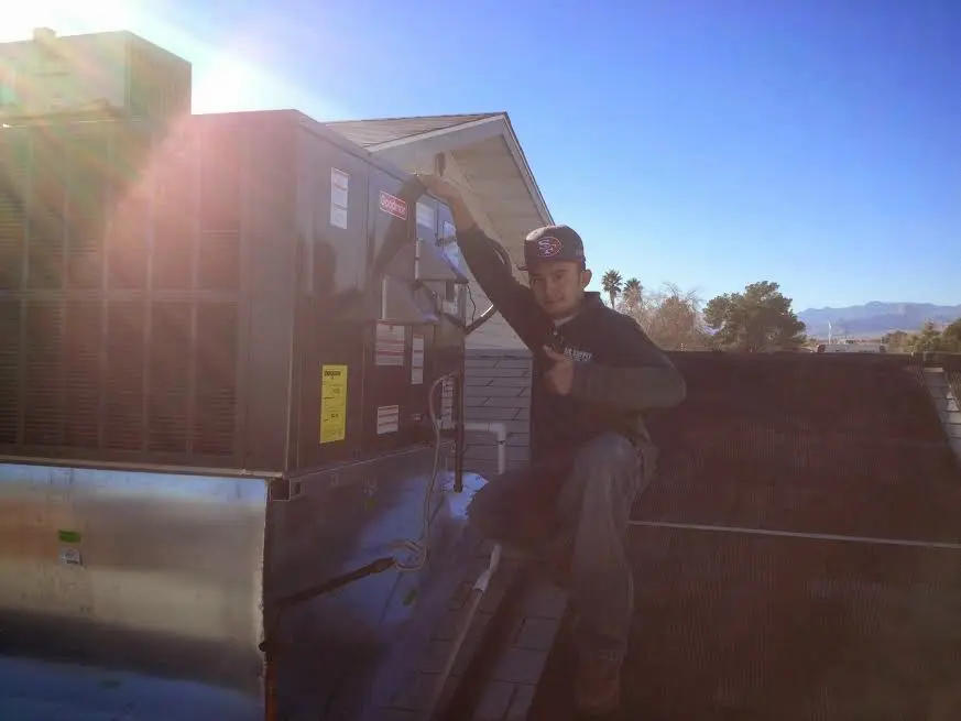 HVAC technician performing Air Duct Repair on a rooftop unit in Port Angeles